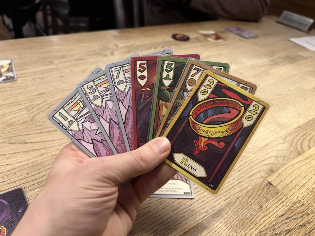 A hand full of cards from the game, each with its fabulous stained glass design scheme.