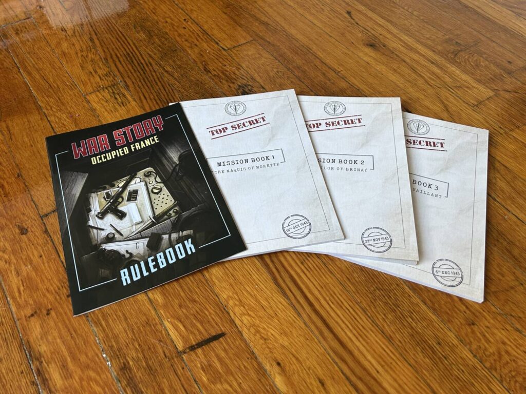 The instruction manual and all three Mission booklets, splayed out on the floor.